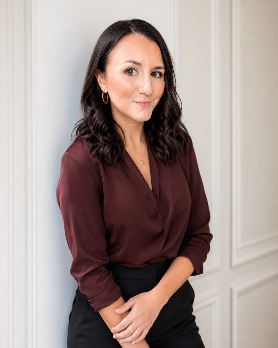 Janie Windmiller, founder of Be The Good Marketing, in a burgundy blouse against a white paneled wall